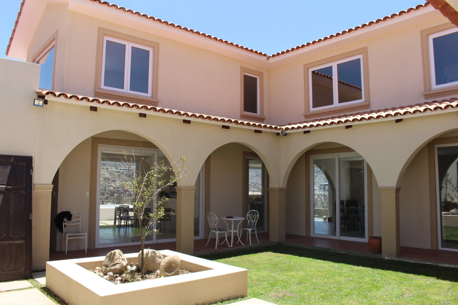 Patio interior con arcos y cerramientos de vidrio
